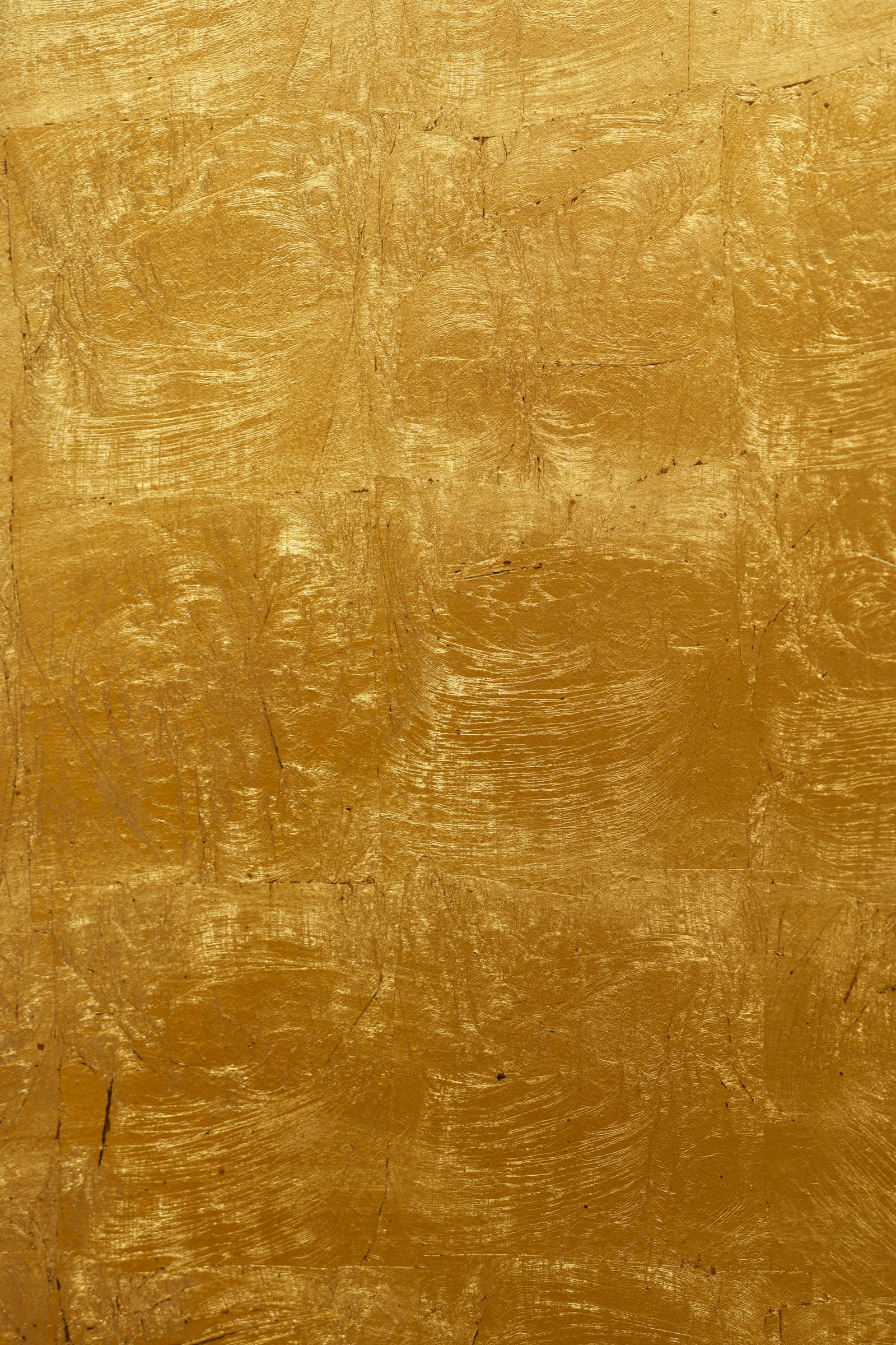 Close-up of stacked gold bars, representing physical-backed precious metal investing.