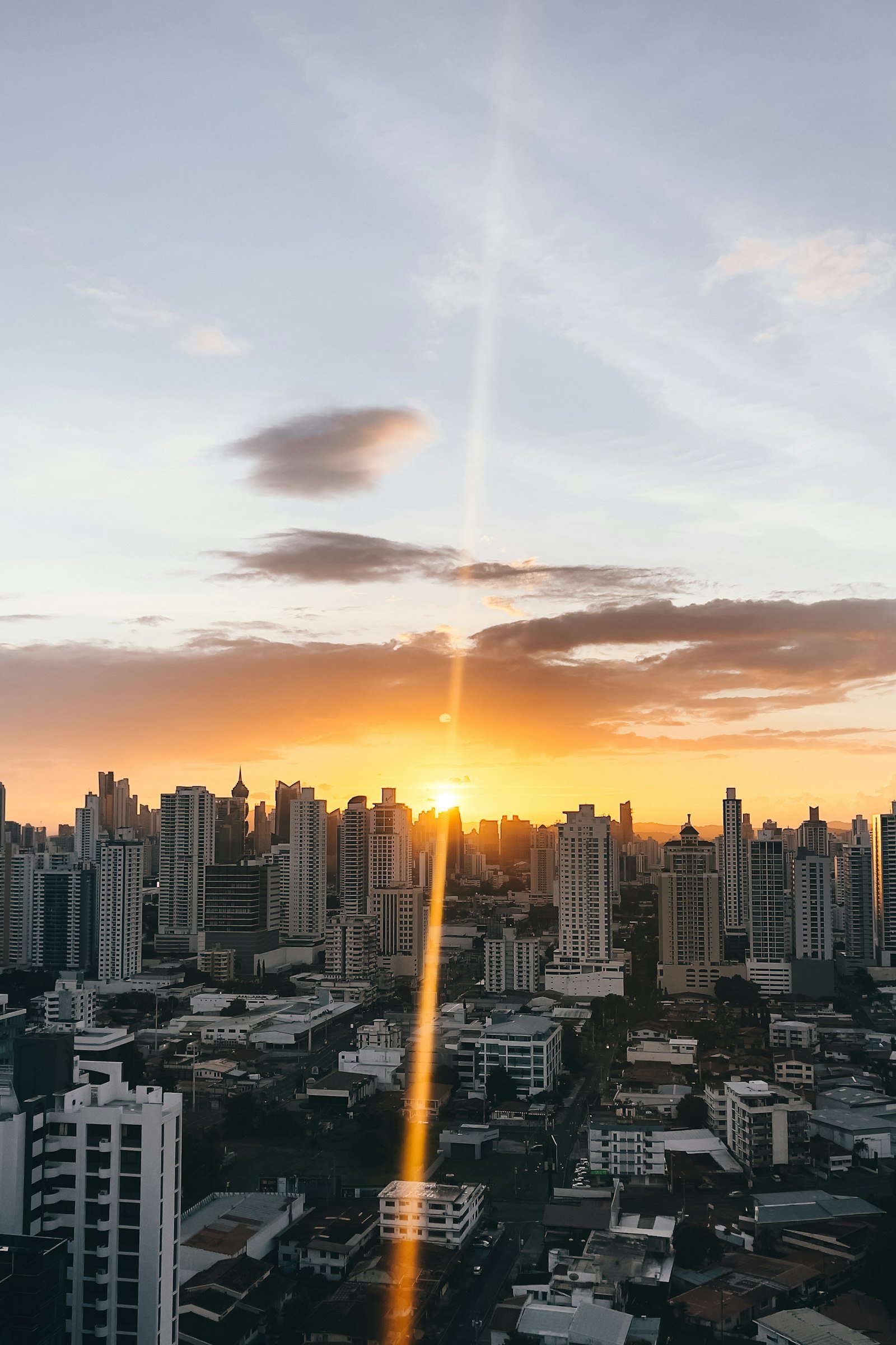 A golden sunrise breaking over a city skyline, representing a company's first day on the public market.
